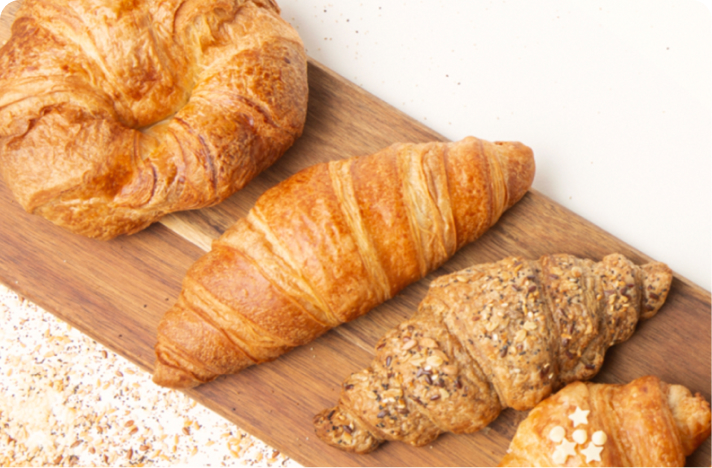 Different high protein croissants on a wooden slab